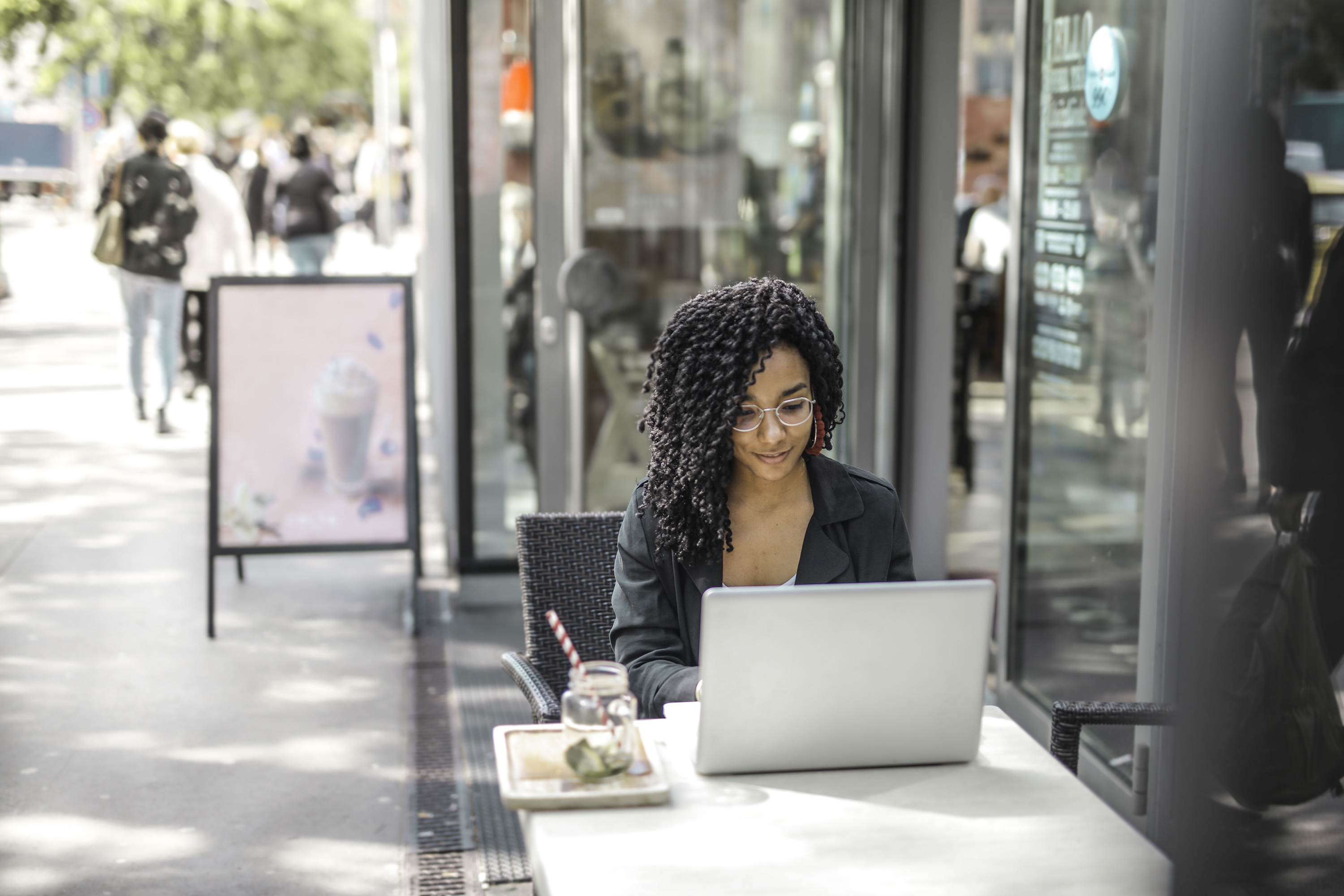 ethnic-young-woman-using-laptop-while-having-tasty-beverage-3768894-(1).jpg